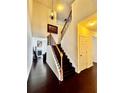View of the staircase with dark wooden steps and wood and iron railings at 3981 Isaac Ct, Lilburn, GA 30047