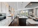 Open-concept kitchen with a large island, modern appliances, and seamless flow to living area at 58 Canton St # 404, Alpharetta, GA 30009