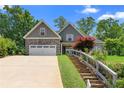 Attractive two-story home boasts stone detailing, a two-car garage, and meticulously maintained landscaping at 114 Brookstone Dr, Carrollton, GA 30116
