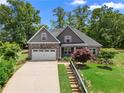 Inviting two-story home featuring stone accents, a two-car garage, and a beautifully landscaped yard at 114 Brookstone Dr, Carrollton, GA 30116