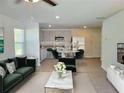Open-concept living room with modern decor seamlessly connecting to the kitchen, perfect for entertaining and everyday living at 115 Deer Xing, Temple, GA 30179
