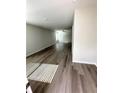 Bright living room showcasing new wood flooring and abundant natural light from the large windows at 528 Earnest Ln, Temple, GA 30179