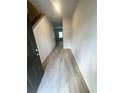 Inviting hallway featuring stylish, light-colored wood flooring and neutral wall colors at 100 Deer Xing, Temple, GA 30179
