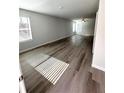 Bright, open living area with modern gray vinyl plank flooring and a ceiling fan at 127 Deer Xing, Temple, GA 30179