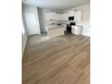 A spacious kitchen with white cabinets, a center island, and modern appliances at 131 Deer Xing, Temple, GA 30179