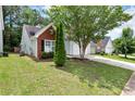 View of the house featuring mature landscaping and a well-manicured lawn at 285 Kentshire Pl, Lawrenceville, GA 30044