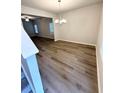 Spacious dining room with wood-look floors, modern lighting, and an open layout at 836 Courthouse Park Dr, Temple, GA 30179