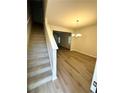 Inviting entryway featuring wood-look floors and a staircase leading to the upper level at 836 Courthouse Park Dr, Temple, GA 30179