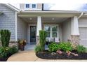 Inviting front porch with seating area, decorative plants, and a stylish entryway at 250 Cordova St, Woodstock, GA 30189
