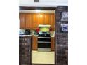 View of the kitchen, including the cabinets, countertops, and the appliances, as seen from an adjacent brick-lined entryway at 4179 Westview St, Douglasville, GA 30135
