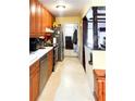 Kitchen with stainless steel appliances, wooden cabinets and white countertops, as seen from a narrow angle at 4179 Westview St, Douglasville, GA 30135
