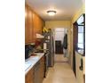 Kitchen with stainless steel appliances, wooden cabinets and white countertops, as seen from a narrow angle at 4179 Westview St, Douglasville, GA 30135