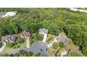 Aerial view of a home in a cul-de-sac surrounded by lush green trees in a quiet neighborhood at 1360 Woodvine Way, Alpharetta, GA 30005