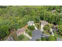 Overhead view of a beautiful home nestled among lush trees in a desirable, quiet neighborhood at 1360 Woodvine Way, Alpharetta, GA 30005