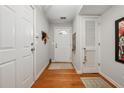Light-filled entryway showcases hardwood floors and a white front door at 200 Valley Xing, Canton, GA 30114