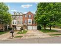 Brick townhome with attached garages, manicured lawn, and mature shade trees at 200 Valley Xing, Canton, GA 30114