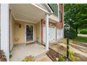 Inviting covered front porch with decorative wreath and adjacent two-car garage at 200 Valley Xing, Canton, GA 30114