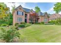 Charming brick home with a well-maintained lawn, lovely landscaping, and a welcoming facade at 2118 Town Manor Ct, Dacula, GA 30019