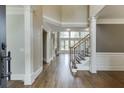 Elegant foyer boasting hardwood floors, a grand staircase, and soaring ceilings with decorative molding at 2118 Town Manor Ct, Dacula, GA 30019