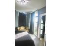 Sunlit bedroom featuring a sitting area, balcony access, and stylish decor at 250 Park Avenue West # 802, Atlanta, GA 30313