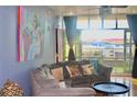 Comfortable living room with a large window, balcony, modern furniture, and vibrant artwork at 250 Park Avenue West # 802, Atlanta, GA 30313
