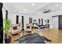 Spacious main bedroom featuring hardwood floors, a seating area, and modern light fixture at 1774 Vesta Ave, Atlanta, GA 30337