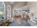 Open floor plan with hardwood floors connecting the living area to the dining and kitchen spaces at 4648 Glenshire Pl, Atlanta, GA 30338