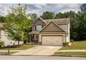 Charming two-story home featuring a two-car garage and a well-manicured front yard with mature landscaping at 856 Donington Cir, Lawrenceville, GA 30045