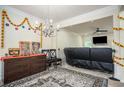 Spacious living room with elegant chandelier, opening into a cozy Gathering room with a fireplace and TV at 856 Donington Cir, Lawrenceville, GA 30045