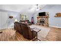 Cozy living room with a stone fireplace and comfortable leather seating at 115 S Meadowcliff Cir, Carrollton, GA 30116