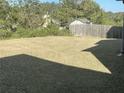A spacious backyard with a grass lawn and natural surrounding environment at 1291 Long Acre Dr, Loganville, GA 30052