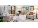 Comfortable living room with a cozy armchair, neutral colors, and access to the balcony at 2707 Cumberland Se Ct, Smyrna, GA 30080