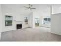 Bright living room with large windows, fireplace, ceiling fan and access to the outdoor deck at 4787 Burford Nw Ct, Acworth, GA 30102