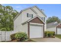 Home featuring a brick garage with well-maintained landscaping at 3979 White Owl Nw Ct, Duluth, GA 30097