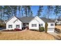 Beautiful single-story home with manicured front lawn, enhanced by the well-kept landscaping and charming details at 6218 Old Stilesboro Nw Rd, Acworth, GA 30101