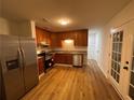 Modern kitchen with stainless steel appliances, wood cabinets, and a stylish backsplash at 6927 Eunice Dr, Riverdale, GA 30274