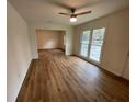 Bright living room featuring hardwood floors and large windows for natural light at 6927 Eunice Dr, Riverdale, GA 30274