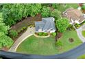 A beautiful home with a landscaped yard, circular driveway, and mature trees provides privacy at 125 Forrest Lake Rd, Johns Creek, GA 30022