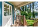 Close up of the charming front porch with a view of the lake at 135 Marina Ct, Canton, GA 30114