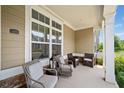 Charming, covered front porch with seating, offering a cozy outdoor space to relax and enjoy the neighborhood at 306 Cherokee Station Cir, Woodstock, GA 30188