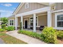 Welcoming front porch with classic columns and seating, enhancing the curb appeal of this charming home at 306 Cherokee Station Cir, Woodstock, GA 30188