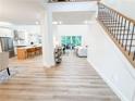 Bright foyer with light wood floors leading to an open-concept living area at 3180 Lee Dr, Buford, GA 30518