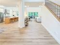 Bright and airy foyer featuring light wood floors, a staircase, and an open view to the living spaces at 3180 Lee Dr, Buford, GA 30518