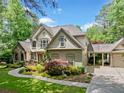 Charming two-story home with stone accents, three-car garage and well-manicured landscaping at 8170 Hurakan Creek Xing, Cumming, GA 30028