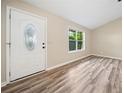 Bright foyer showcasing wood-look flooring, a modern front door, and a window with natural light at 162 Riverchase Dr, Woodstock, GA 30188