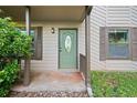Inviting front door with decorative glass, complemented by stylish shutters and manicured greenery at 162 Riverchase Dr, Woodstock, GA 30188