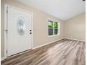 Bright living room features elegant flooring, a large window, and a welcoming front door at 162 Riverchase Dr, Woodstock, GA 30188