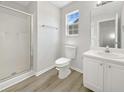 Bright bathroom with a glass-enclosed shower, white cabinets, and modern fixtures at 2628 Downingwood Ln, Grayson, GA 30017