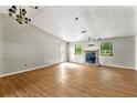 A spacious living room features a stone fireplace, wood floors, and natural light at 5445 Mallard Trl, Lithonia, GA 30058