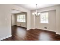Inviting dining room featuring hardwood floors, neutral paint, and a modern chandelier at 5911 Christopher Ln, Lithonia, GA 30058